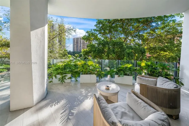 a view of a porch with furniture and a yard