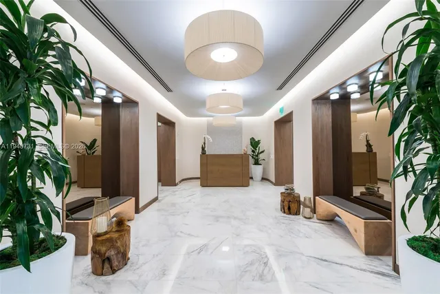 a living room with furniture and large windows