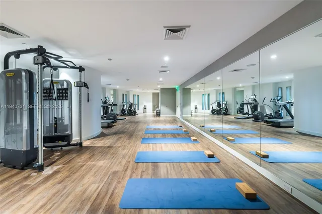 a room with lots of wooden furniture and potted plants