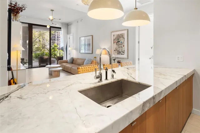 a kitchen with stainless steel appliances a sink a stove and a granite counter tops with garden view