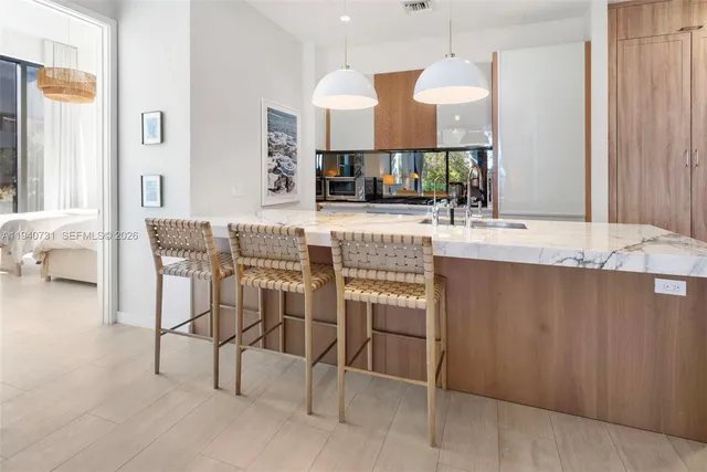 a view of dining table chairs and chandelier