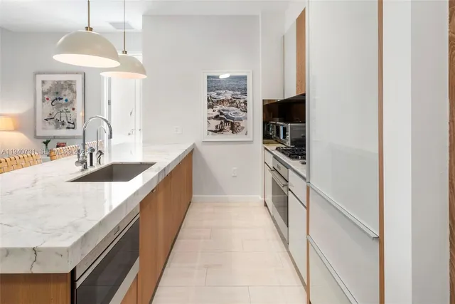 a kitchen with a sink and refrigerator
