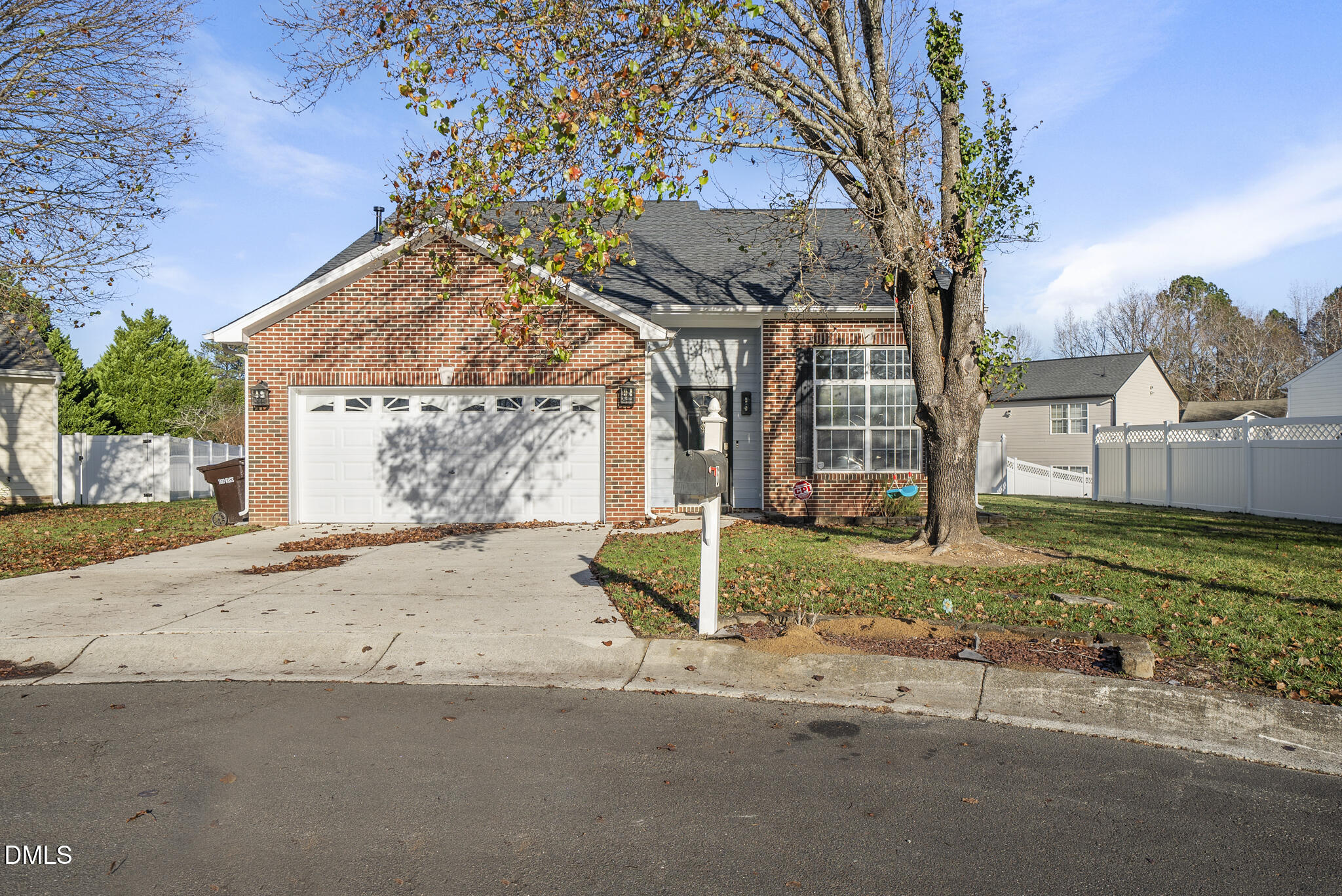 a view of a house with a yard and tree s