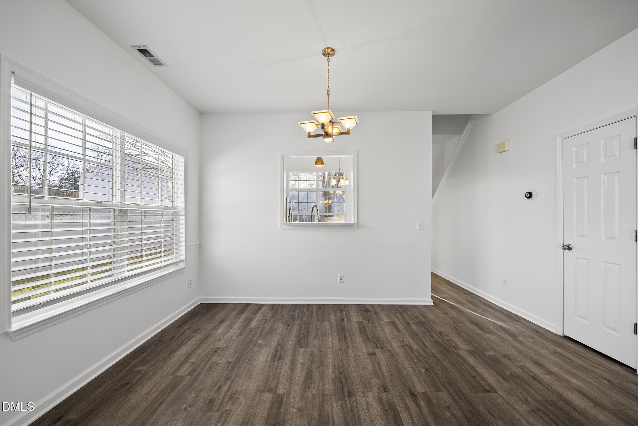 6 Cibola Court Durham, NC 27713 - Photo 10 of 30 a view of an empty room with wooden floor and a window