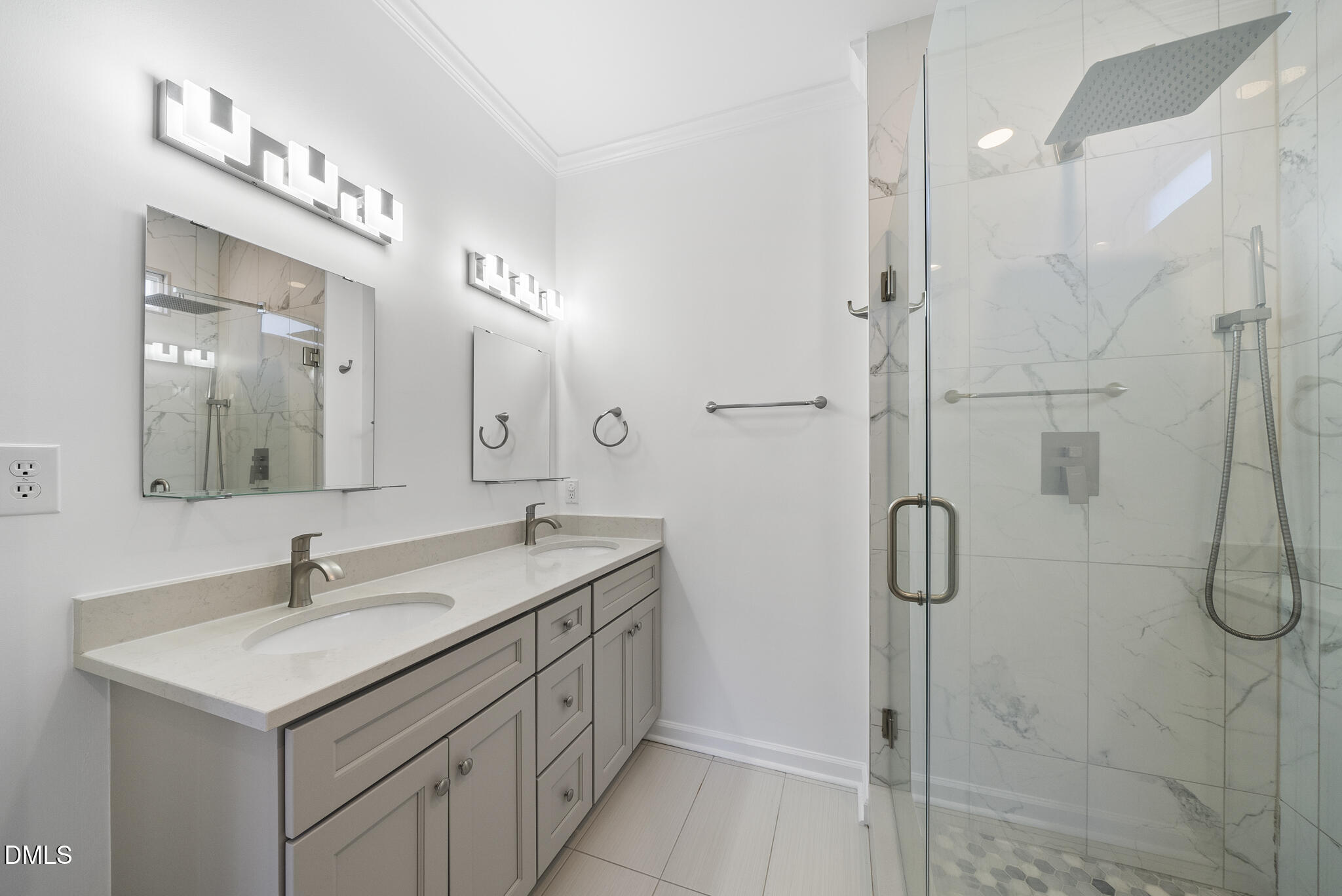 6 Cibola Court Durham, NC 27713 - Photo 17 of 30 a bathroom with a double vanity sink a mirror and a shower