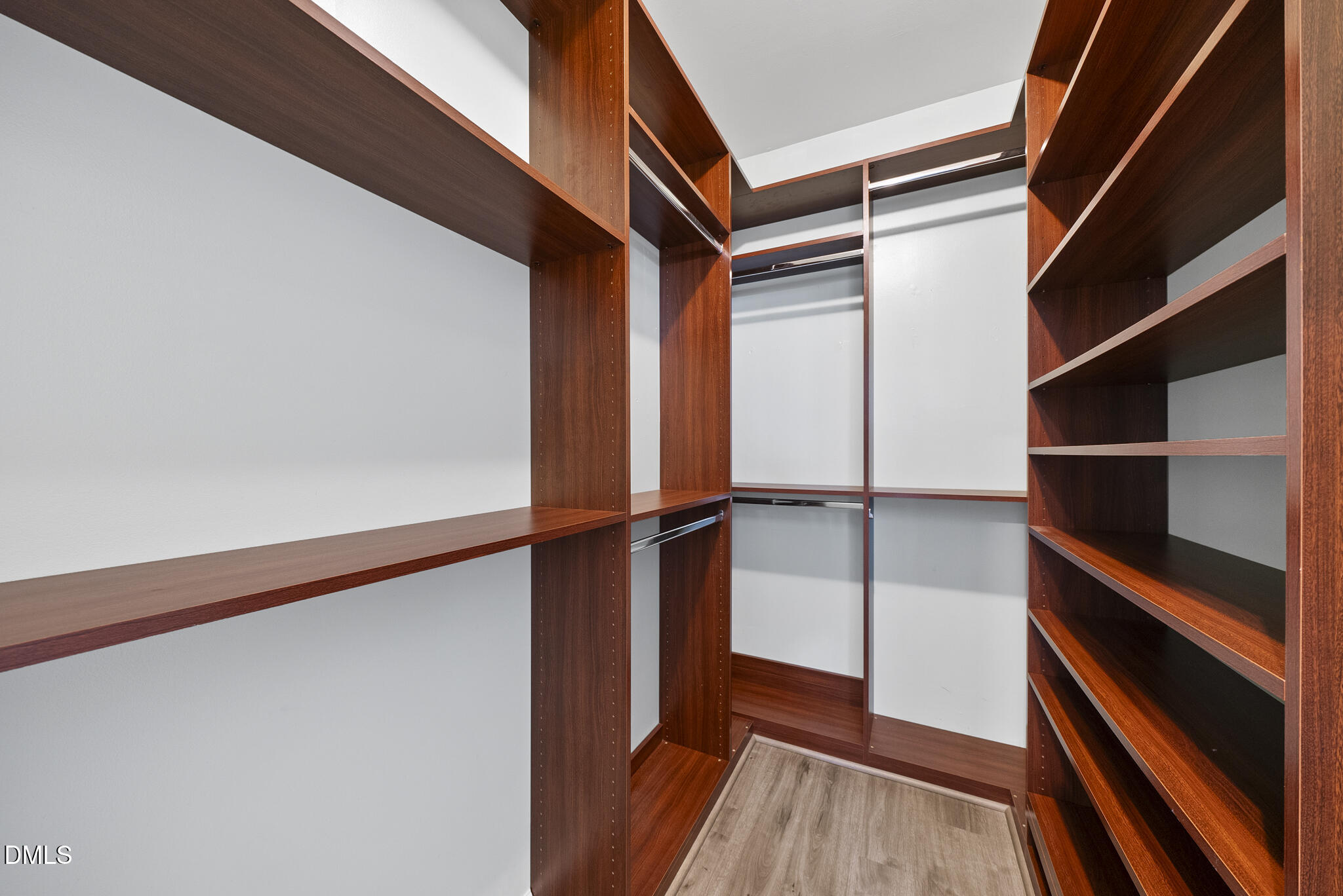 6 Cibola Court Durham, NC 27713 - Photo 18 of 30 a view of walk in closet with wooden floor and small window