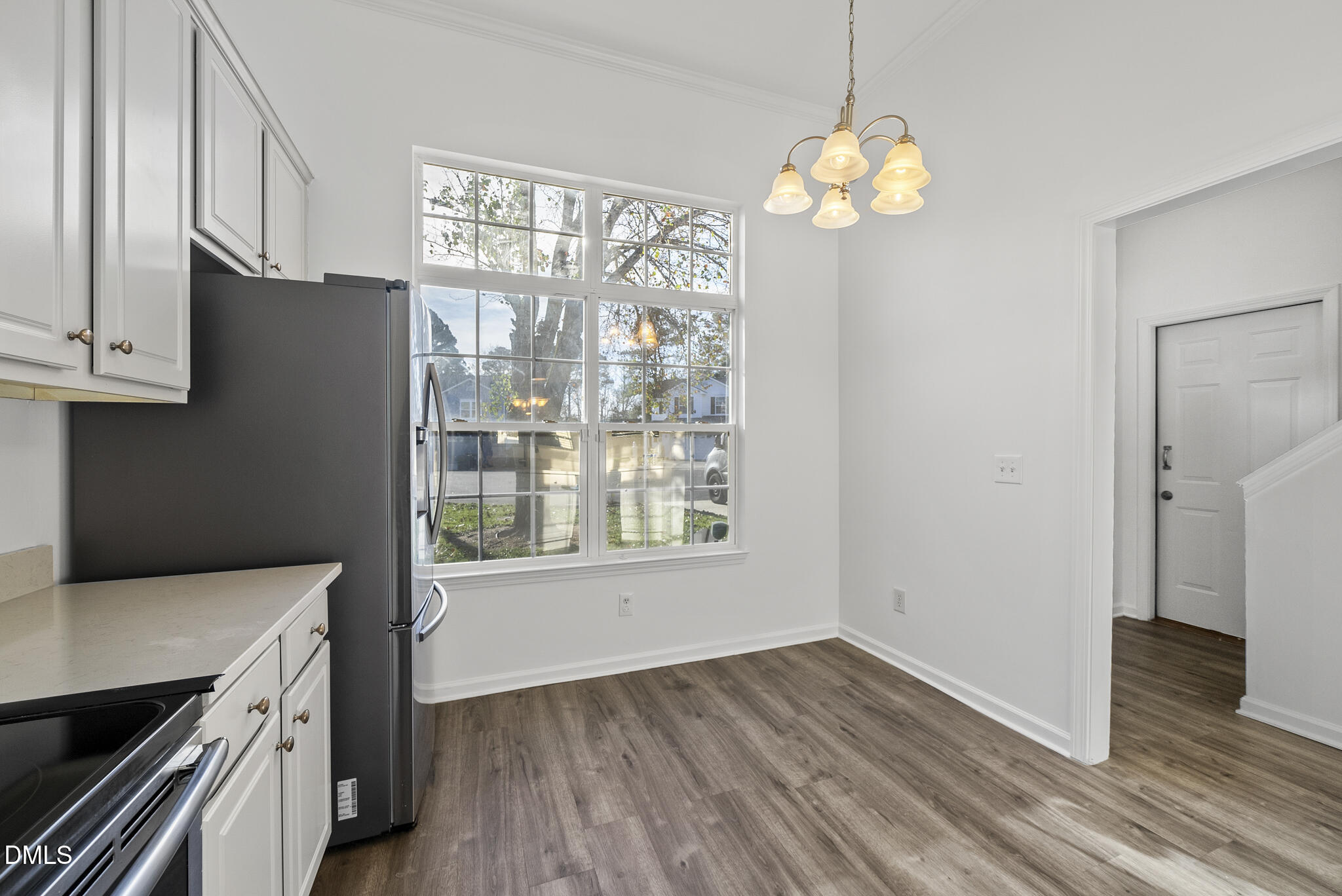 6 Cibola Court Durham, NC 27713 - Photo 8 of 30 a view of an empty room with wooden floor and a window