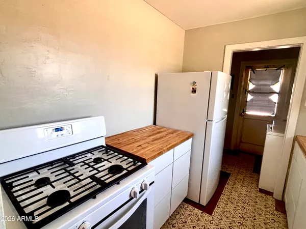a kitchen with blue cabinets and a stove top oven