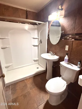a bathroom with a sink a toilet and a mirror