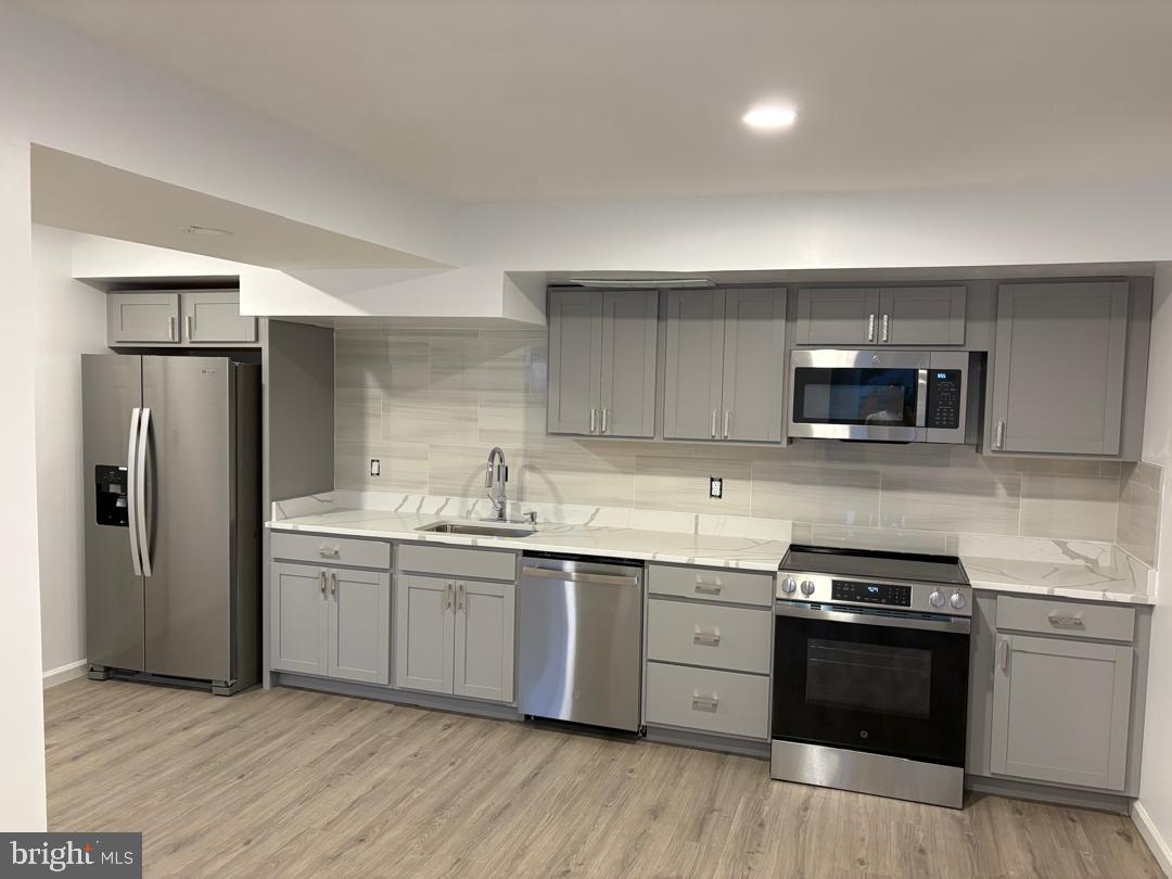 2016 Gatewood Place Silver Spring, MD 20903 - Photo 6 of 24 a kitchen with stainless steel appliances granite countertop a sink stove and refrigerator