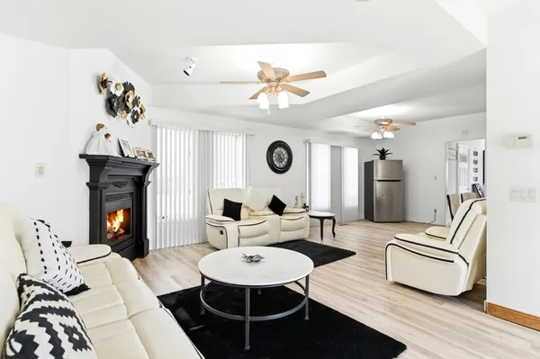 a living room with furniture a fireplace and a table