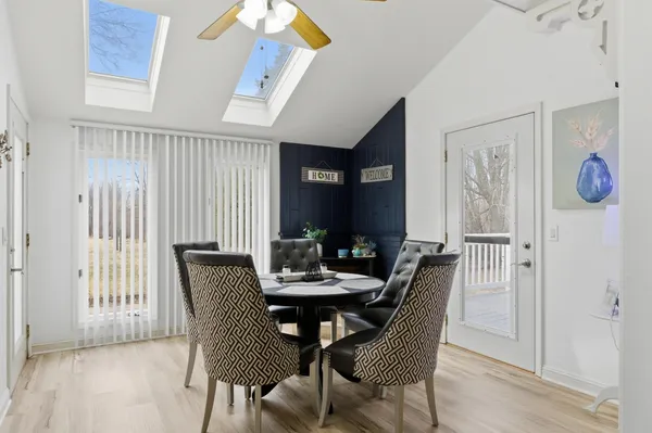 a view of a dining room with furniture and window