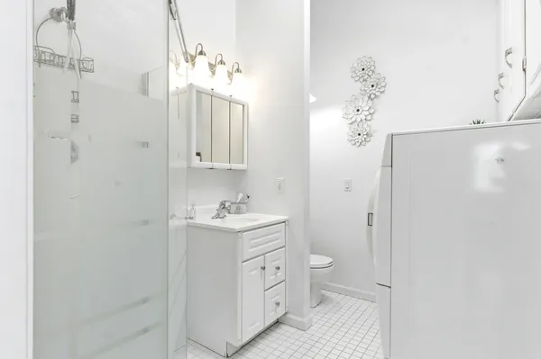 a bathroom with a double vanity sink mirror and shower