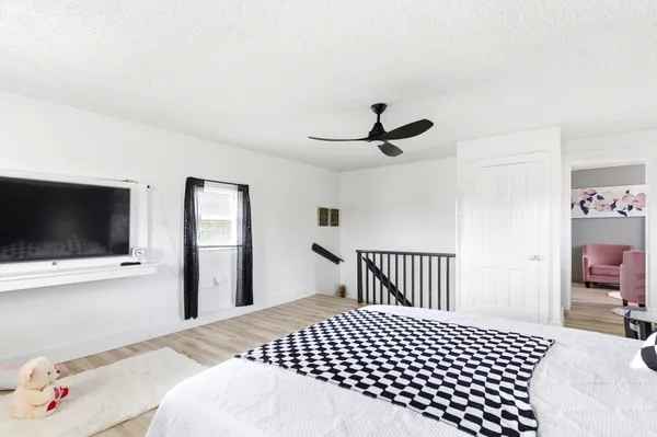 a bedroom with a bed and a flat screen tv