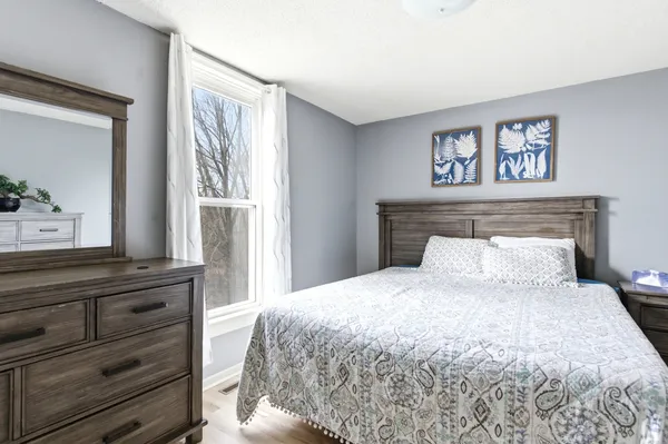 a bedroom with a large bed and a window