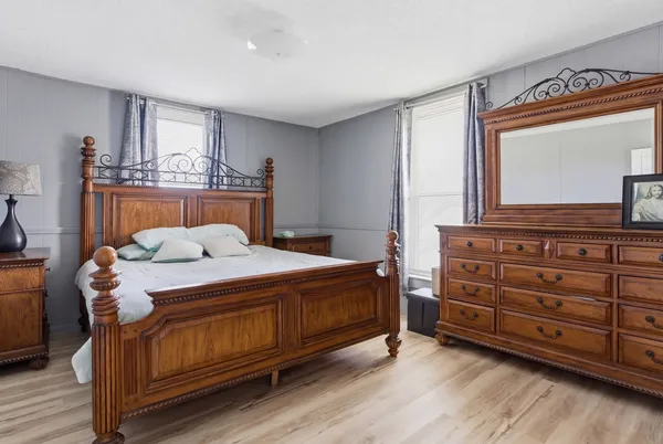 a bedroom with a bed and a dresser