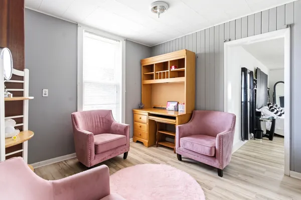 a living room with furniture a rug and a window