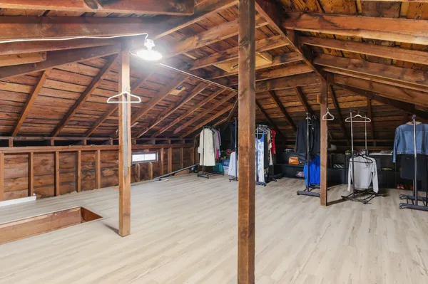 a view of a room with wooden floor