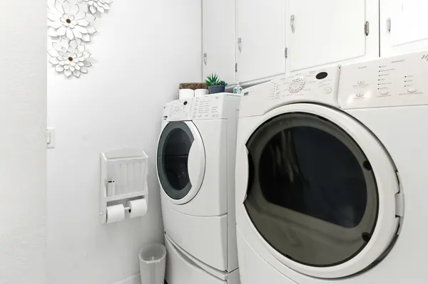 a close view of a utility room with dryer and washer