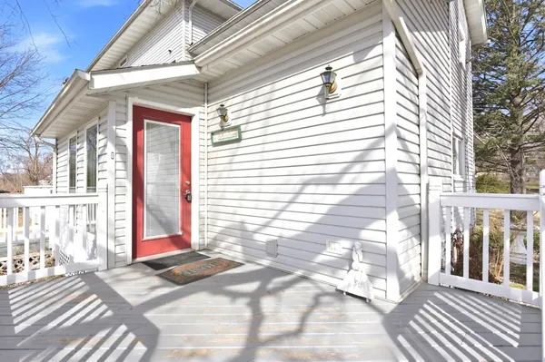 a view of a balcony with wooden floor and floor to ceiling window