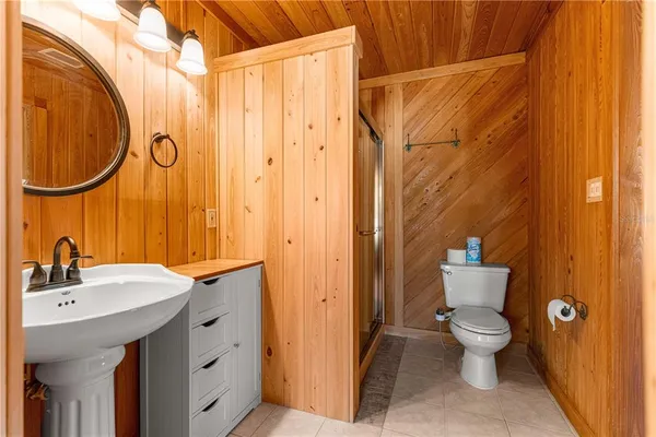 a dining room with furniture a chandelier and wooden floor