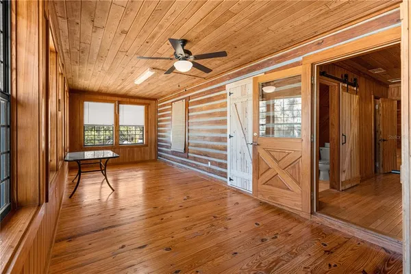 a view of empty room with wooden floor