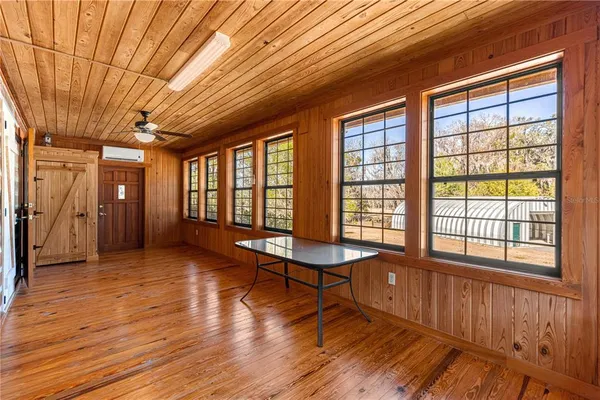 a living room with furniture windows and wooden floor