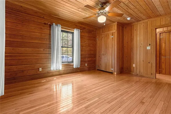 a room with a wooden floor and large window