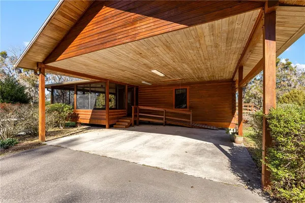 a view of a patio with table and chairs and potted plants