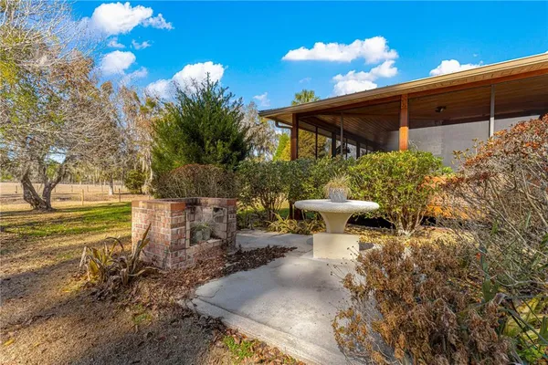 a view of a room with furniture and wooden floor