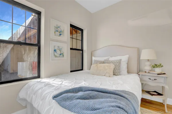 a bedroom with a bed and a painting on the wall