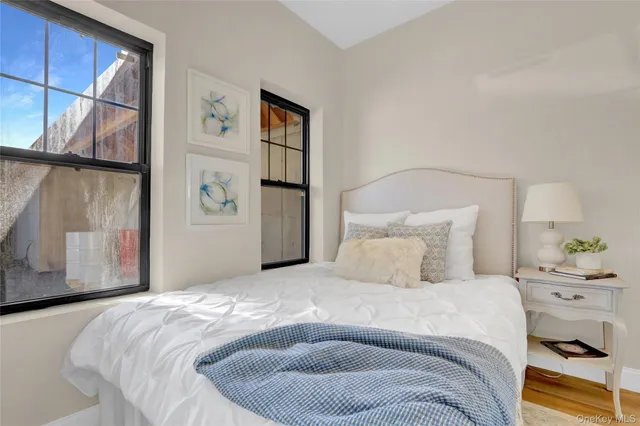 a bedroom with a bed and a painting on the wall