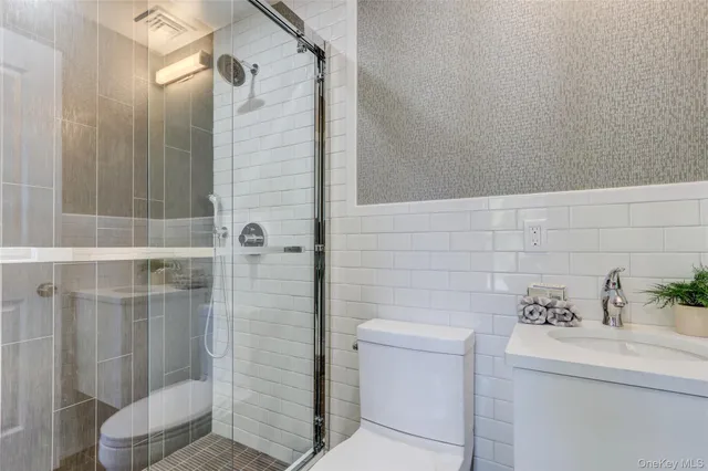 a bathroom with a shower and a sink