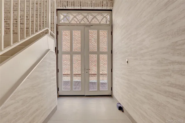 a view of an entryway with a floor to ceiling window