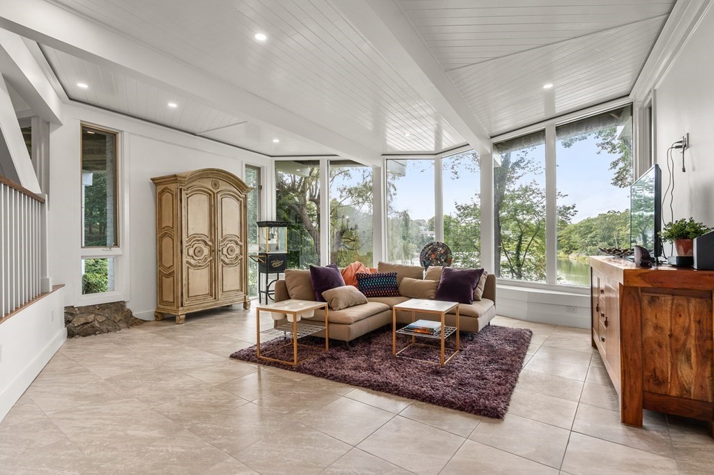 78 Nichols Road Cohasset, MA 02025 - Photo 14 of 23 a living room with furniture large windows a rug and a chandelier