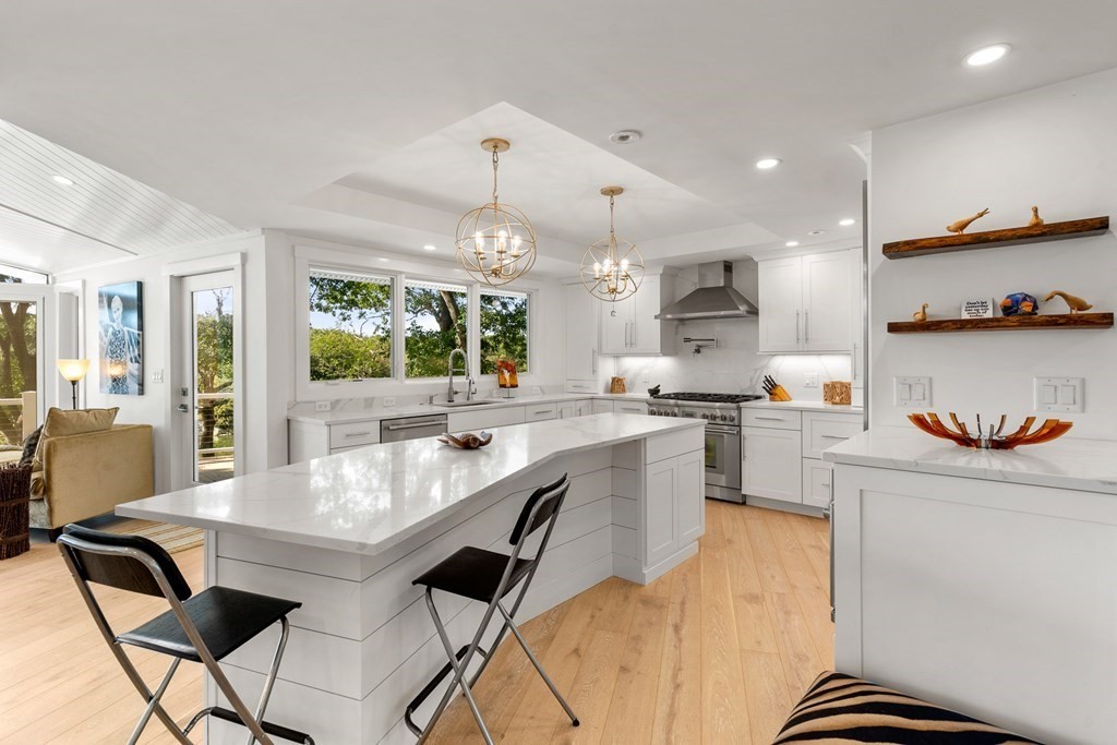 78 Nichols Road Cohasset, MA 02025 - Photo 4 of 23 a kitchen with granite countertop white cabinets and stainless steel appliances