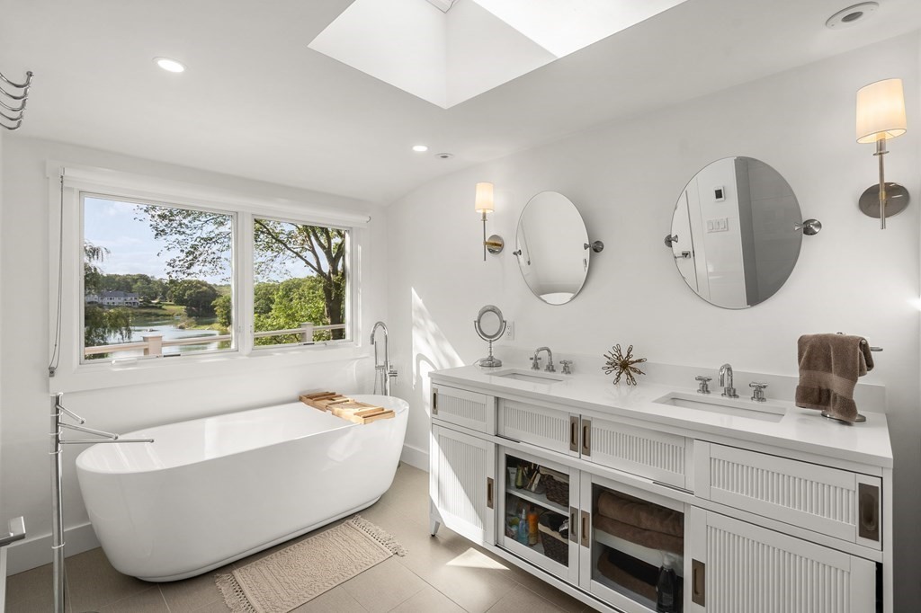 78 Nichols Road Cohasset, MA 02025 - Photo 10 of 23 a bathroom with a double vanity sink a large mirror and a bathtub
