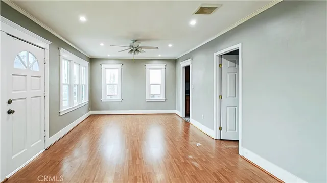 an empty room with wooden floor and closet