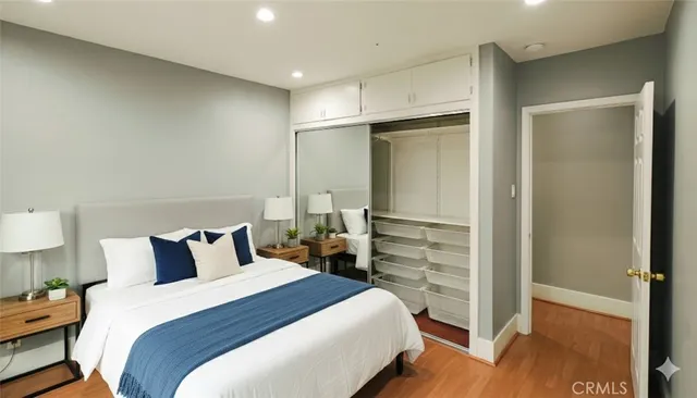 a bedroom with a bed and wooden floor