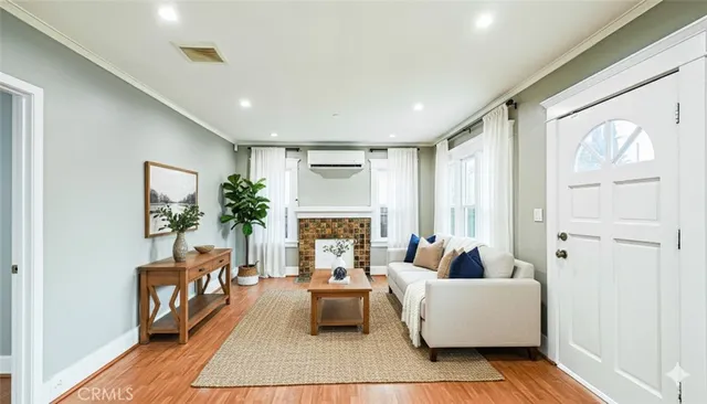 a living room with furniture fireplace and a large window