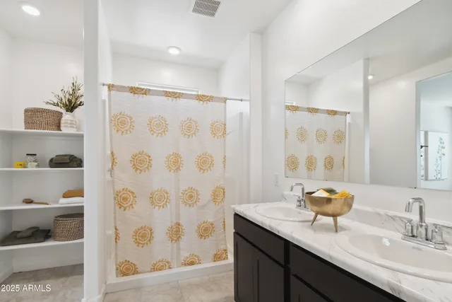 a bathroom with a granite countertop sink a toilet and a shower