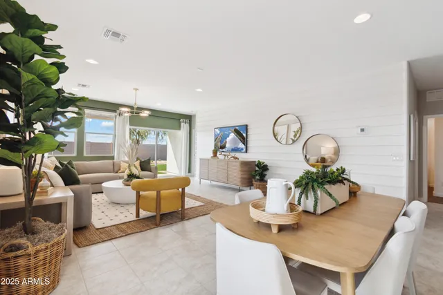 a living room with furniture a chandelier and a dining room