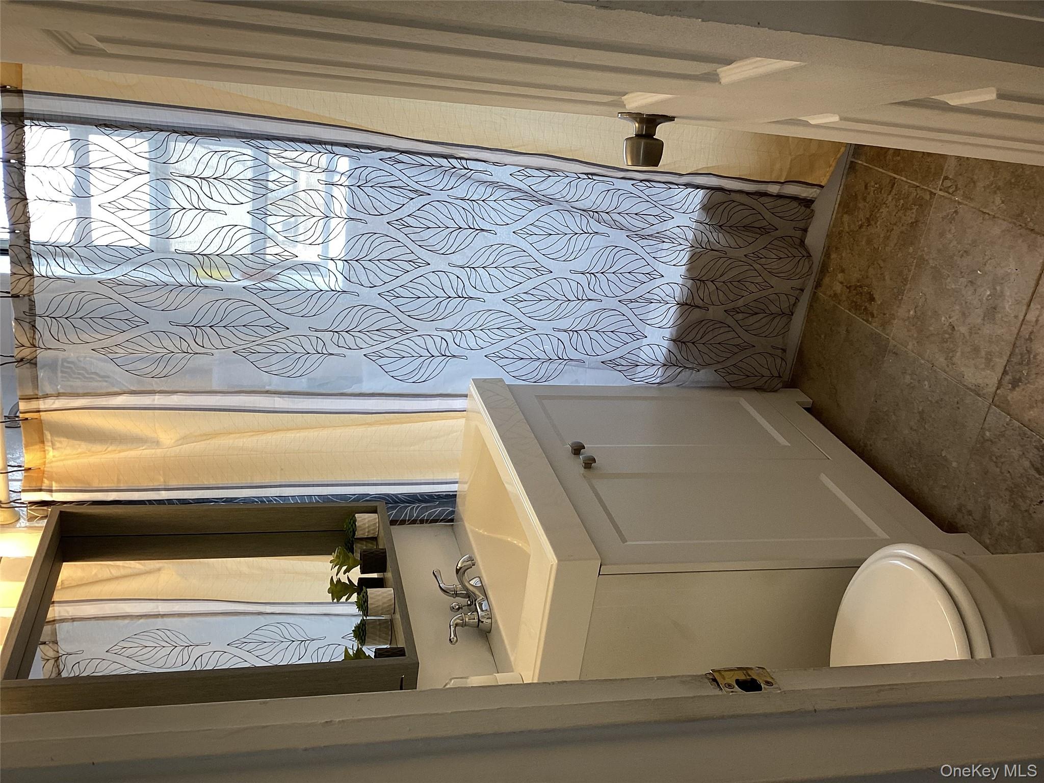 3176 Decatur Avenue, Unit 4F Bronx, NY 10467 - Photo 11 of 13 a bathroom with a sink a toilet and a mirror