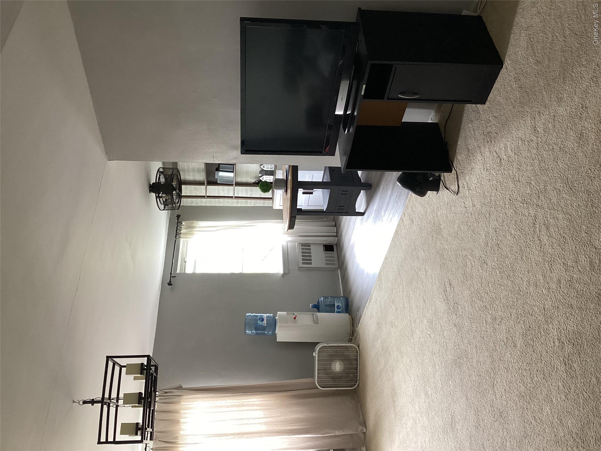 3176 Decatur Avenue, Unit 4F Bronx, NY 10467 - Photo 12 of 23 a living room with furniture and a flat screen tv