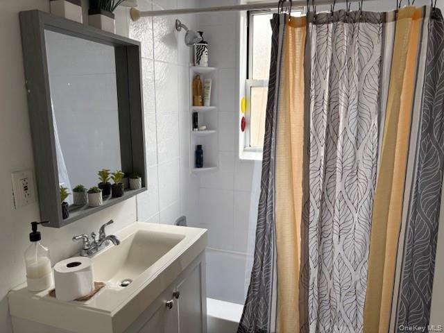 3176 Decatur Avenue, Unit 4F Bronx, NY 10467 - Photo 17 of 23 a bathroom with a sink a mirror a vanity and a shower