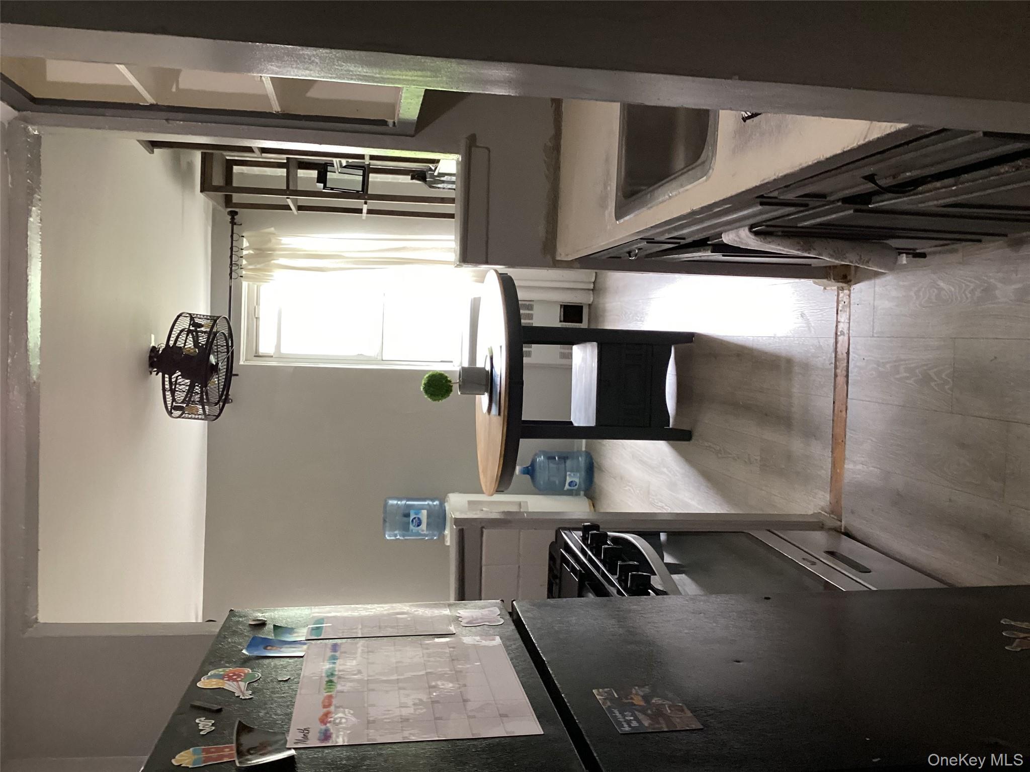 3176 Decatur Avenue, Unit 4F Bronx, NY 10467 - Photo 5 of 13 a kitchen with stainless steel appliances granite countertop a stove a sink and a refrigerator