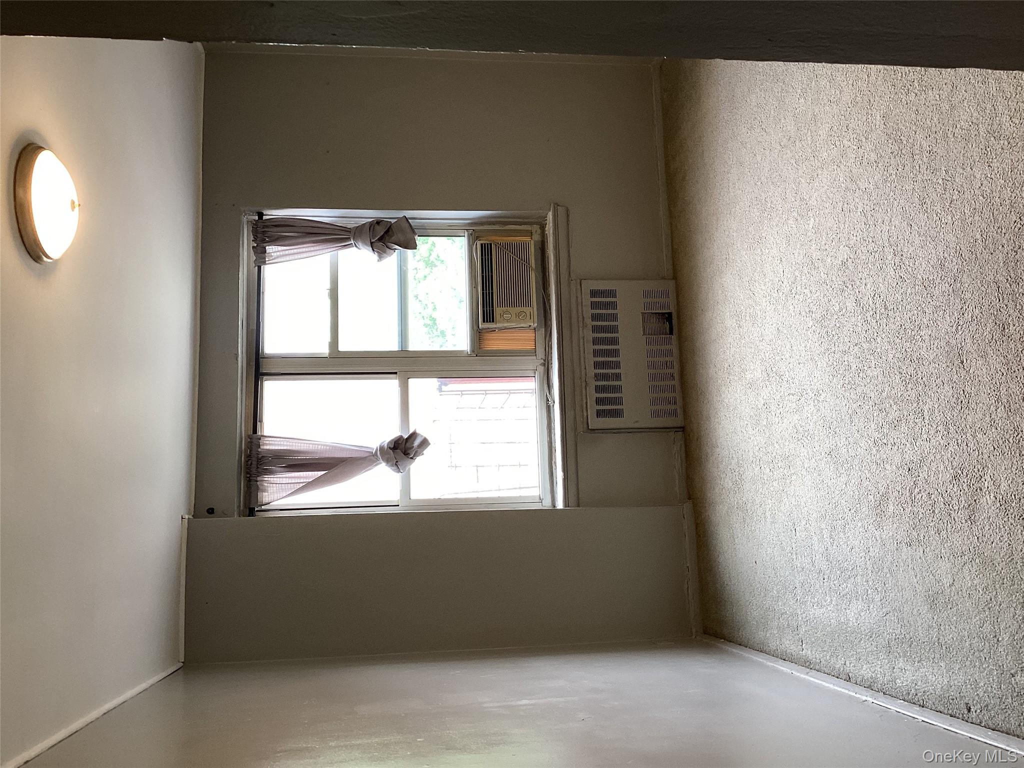 3176 Decatur Avenue, Unit 4F Bronx, NY 10467 - Photo 9 of 13 an empty room with a window