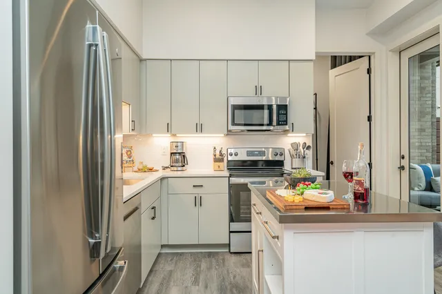 a kitchen with a sink a stove and cabinets