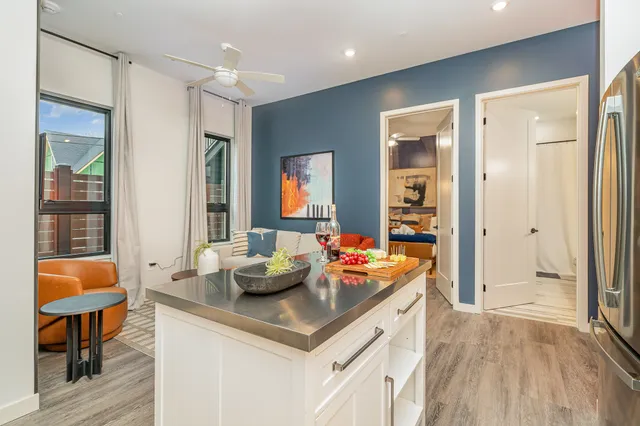 a living room with blue lights with furniture and wooden floor