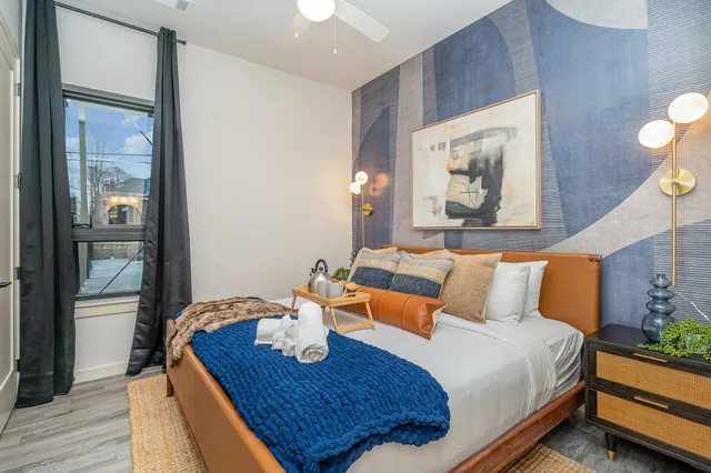 a bedroom with a bed and wooden floor